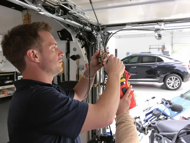 Stanton Garage Door Repair safety certified technician performing cable replacement in Stanton